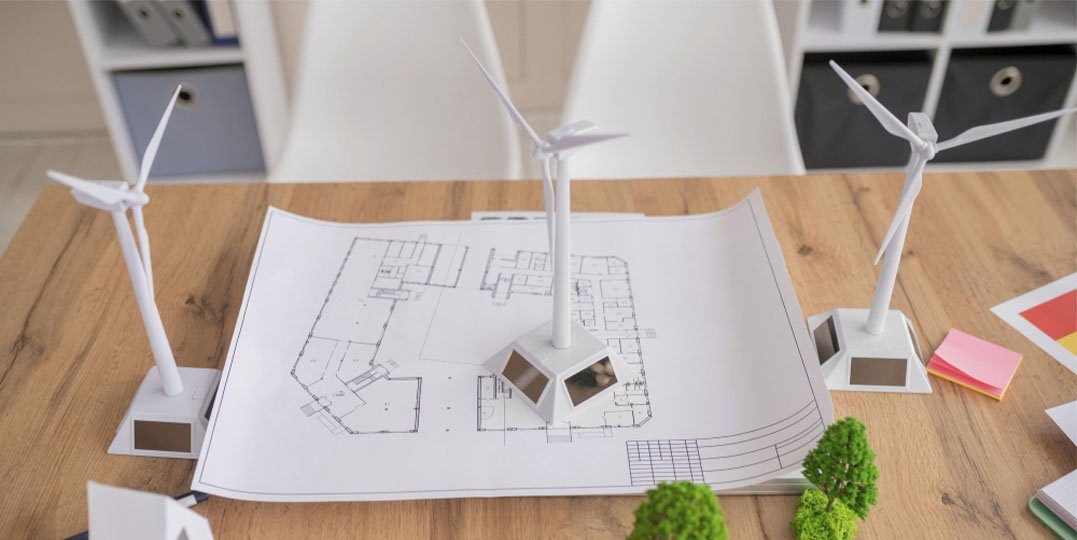 Plano de una instalación con maquetas de aerogeneradores sobre una mesa